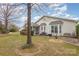 Charming home featuring a well-manicured lawn, mature trees, and an inviting screened porch at 786 Platinum Dr, Fort Mill, SC 29708