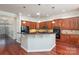 Modern kitchen with dark countertops, wood cabinets, stainless steel appliances, and recessed lighting at 786 Platinum Dr, Fort Mill, SC 29708