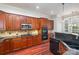 Contemporary kitchen with stainless steel appliances, dark countertops, wood cabinetry, and tiled backsplash at 786 Platinum Dr, Fort Mill, SC 29708