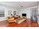 Comfortable living room featuring a ceiling fan, hardwood floors, and a view of the foyer from the open layout at 786 Platinum Dr, Fort Mill, SC 29708