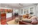 Open-concept living space with hardwood floors, a breakfast bar, and seamless flow to the kitchen and dining area at 786 Platinum Dr, Fort Mill, SC 29708