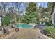 Beautiful backyard showcasing a pool, hot tub, lush landscaping, and lounge chairs at 830 Jefferson Dr, Charlotte, NC 28270