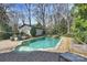 This backyard features a pool, hot tub, and ample trees for backyard privacy at 830 Jefferson Dr, Charlotte, NC 28270
