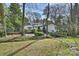 A serene backyard with mature trees, featuring a wooden bridge, hammock and fenced area, perfect for nature lovers at 830 Jefferson Dr, Charlotte, NC 28270