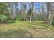 Expansive backyard featuring lush greenery, offering a serene escape and room to enjoy the outdoors at 830 Jefferson Dr, Charlotte, NC 28270