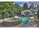 Backyard showcasing a pool, hot tub, a patio, and mature landscaping at 830 Jefferson Dr, Charlotte, NC 28270