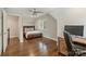 Bedroom featuring hardwood floors, plantation shutters and wood desk at 830 Jefferson Dr, Charlotte, NC 28270