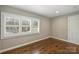 Bedroom with hardwood floors and window with plantation shutters at 830 Jefferson Dr, Charlotte, NC 28270
