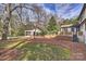 View of a house with a detached garage, featuring a manicured lawn and stone accents at 830 Jefferson Dr, Charlotte, NC 28270