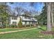 Charming two-story home with a landscaped yard and a brick walkway leading to the front door at 830 Jefferson Dr, Charlotte, NC 28270