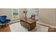 Well-lit office space with hardwood desk, plush chair, and neutral decor for a professional atmosphere at 830 Jefferson Dr, Charlotte, NC 28270
