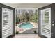 A view of the backyard pool and patio from inside the living room at 830 Jefferson Dr, Charlotte, NC 28270