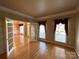 Spacious living room with hardwood floors, natural light, and glass doors to dining room at 10216 Willingham Rd, Huntersville, NC 28078