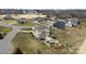 Back exterior view of home with a spacious backyard featuring a private pool, cabana, and lush landscaping at 103 Caddies Ct, Shelby, NC 28150