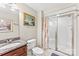 Cozy bathroom featuring a marble vanity, toilet, and a glass-doored shower at 103 Caddies Ct, Shelby, NC 28150
