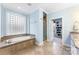 Bright bathroom features a large tub, glass block window, and a walk-in shower at 103 Caddies Ct, Shelby, NC 28150