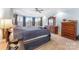 A primary bedroom has a bay window, tray ceiling, and custom wood furniture at 103 Caddies Ct, Shelby, NC 28150