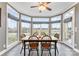 Cozy breakfast nook offering panoramic views with large windows and a ceiling fan above the dining set at 103 Caddies Ct, Shelby, NC 28150
