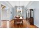 Elegant dining area with wooden floors, large windows, and a traditional china cabinet with a chandelier at 103 Caddies Ct, Shelby, NC 28150