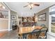 Dining area with hardwood floors, large windows, and a glimpse into the connected kitchen at 103 Caddies Ct, Shelby, NC 28150