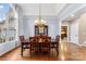 Formal dining room showcases a classic chandelier, wooden table, and large windows for abundant natural light at 103 Caddies Ct, Shelby, NC 28150