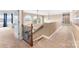 Hallway featuring wooden banister, arched windows, and neutral walls offering brightness and style at 103 Caddies Ct, Shelby, NC 28150