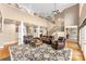 Open living room features soaring ceilings, leather seating, hardwood floors and staircase at 103 Caddies Ct, Shelby, NC 28150