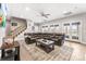 Open living room featuring a large sectional couch, area rug, and staircase at 103 Caddies Ct, Shelby, NC 28150