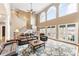 Spacious living room with high ceilings, large windows, leather furniture, and elegant staircase at 103 Caddies Ct, Shelby, NC 28150