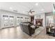 Living room features a fireplace, leather sofa, and multiple french doors to the pool at 103 Caddies Ct, Shelby, NC 28150