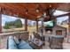 Comfortable outdoor lounge with a stone fireplace and flatscreen TV at 103 Caddies Ct, Shelby, NC 28150