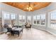 Bright sunroom featuring tile floors, wood ceiling with fan, and windows offering scenic views at 103 Caddies Ct, Shelby, NC 28150