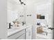 Bright bathroom featuring a double vanity, modern fixtures, and a glimpse of the bedroom through the doorway at 1030 Rolling Meadows Dr # Rm13, Mooresville, NC 28115