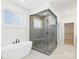 Bright bathroom featuring a modern soaking tub, glass shower with gray tiling, and natural light at 1030 Rolling Meadows Dr # Rm13, Mooresville, NC 28115