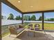 Enjoy the outdoors in comfort with this covered patio featuring stylish furniture and a serene view of the green yard at 1030 Rolling Meadows Dr # Rm13, Mooresville, NC 28115