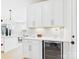 Elegant kitchen with custom white cabinetry, wine cooler, and herringbone backsplash design at 1030 Rolling Meadows Dr # Rm13, Mooresville, NC 28115