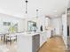 Modern kitchen featuring white cabinets, a kitchen island, and stainless steel appliances open to dining at 1030 Rolling Meadows Dr # Rm13, Mooresville, NC 28115