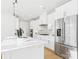 Modern kitchen boasts stainless steel refrigerator, a large island, and sleek white countertops and cabinets at 1030 Rolling Meadows Dr # Rm13, Mooresville, NC 28115