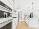 Bright kitchen features stainless steel appliances, white cabinets, and a central island, perfect for cooking at 1030 Rolling Meadows Dr # Rm13, Mooresville, NC 28115