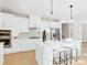 Elegant kitchen with white cabinets, an island with seating, and stylish pendant lighting at 1030 Rolling Meadows Dr # Rm13, Mooresville, NC 28115