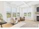 Cozy living room featuring large windows, stylish seating, and a modern fireplace with stone surround at 1030 Rolling Meadows Dr # Rm13, Mooresville, NC 28115