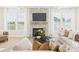 Comfortable living room with a stone fireplace, a large TV, and lots of natural light through the windows at 1030 Rolling Meadows Dr # Rm13, Mooresville, NC 28115