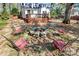 Relaxing backyard with a stone fire pit, chairs and plenty of sunshine at 1101 Lancaster Ave, Monroe, NC 28112