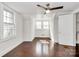 Bright bedroom featuring a ceiling fan, hardwood floors, and natural light at 1101 Lancaster Ave, Monroe, NC 28112