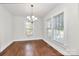Bright dining room with hardwood floors, two large windows, and chandelier lighting at 1101 Lancaster Ave, Monroe, NC 28112