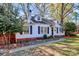 Well-maintained home exterior featuring charming curb appeal with trees and shrubs at 1101 Lancaster Ave, Monroe, NC 28112