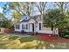 Charming home exterior with manicured lawn, shrubbery, and fenced yard at 1101 Lancaster Ave, Monroe, NC 28112