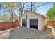 Two-car garage with black doors and ample parking space, as well as an American Flag at 1101 Lancaster Ave, Monroe, NC 28112