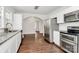Bright kitchen with stainless steel appliances, granite countertops, hardwood floors, and view into other rooms at 1101 Lancaster Ave, Monroe, NC 28112