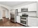 Modern kitchen with stainless steel appliances, granite countertops, hardwood floors, and bright lighting at 1101 Lancaster Ave, Monroe, NC 28112